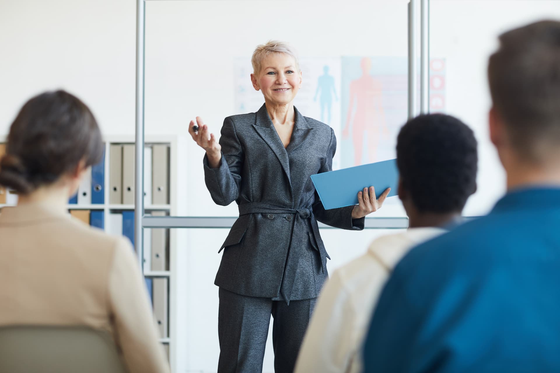 A facilitator presenting to a seated group in an office