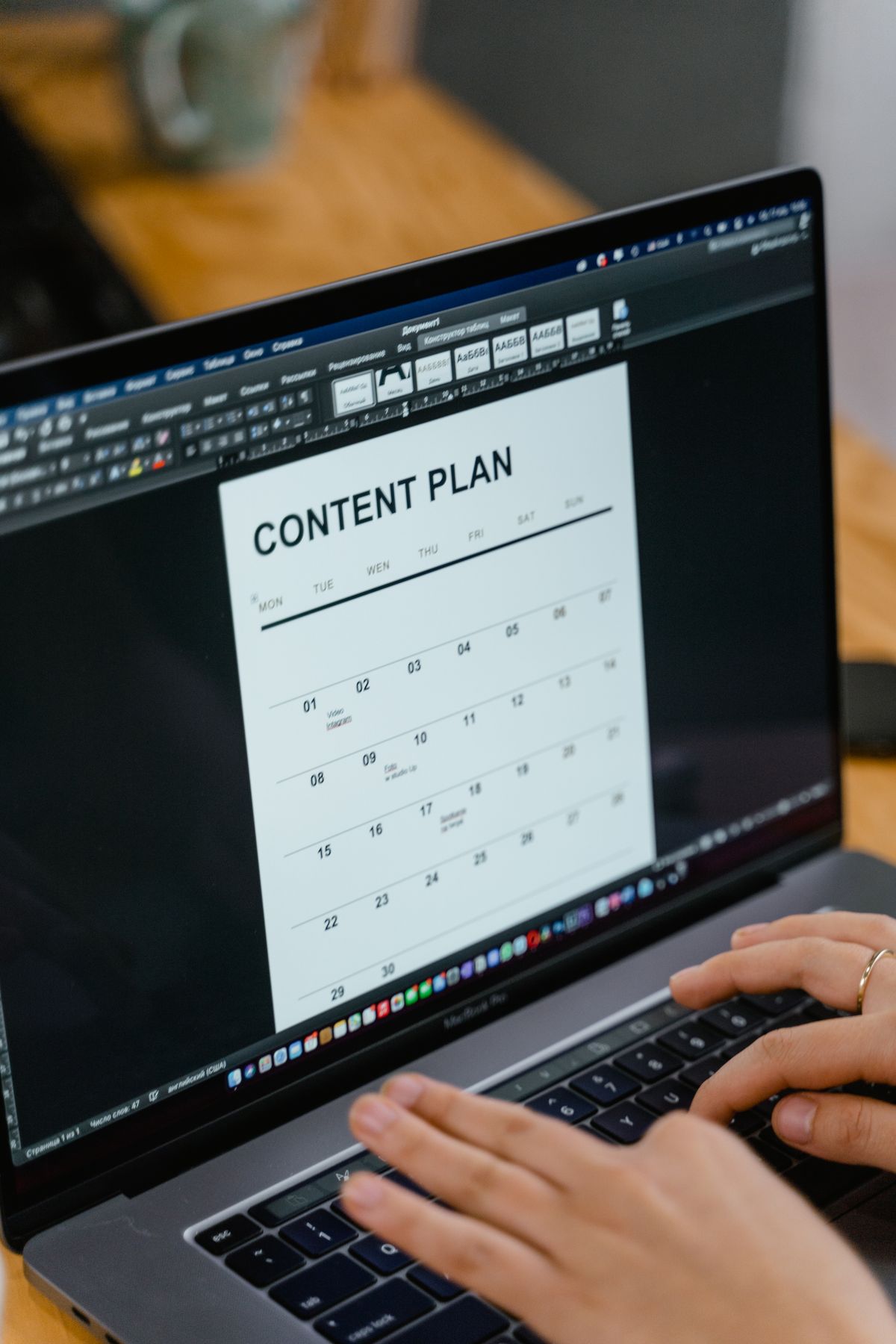 A person viewing a content plan calendar on a laptop
