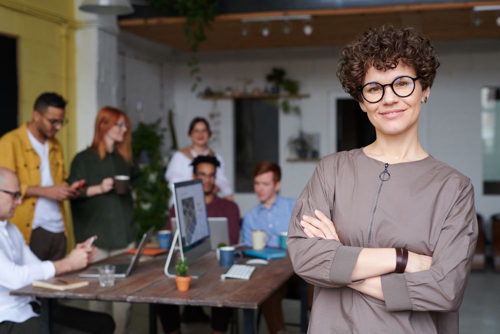 A manager standing in front of her team in an office