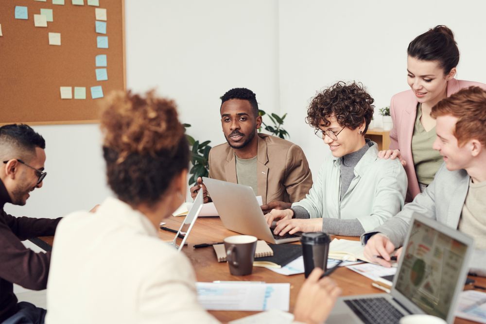 A group of colleagues working and learning together at a shared table